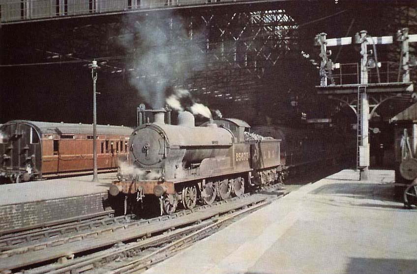 Ex-LNWR 4P 4-6-0 Prince of Wales class No 25673 'Lusitania' is seen standing at the West end of Platform 2 at the head of a down express service to Manchester