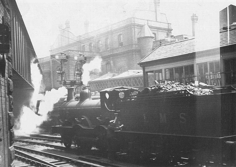 Midland Railway 1P 2-4-0 No 20002 is seen again paused alongside No 2 Signal Cabin at the East end of New Street station in front of Queens Drive bridge