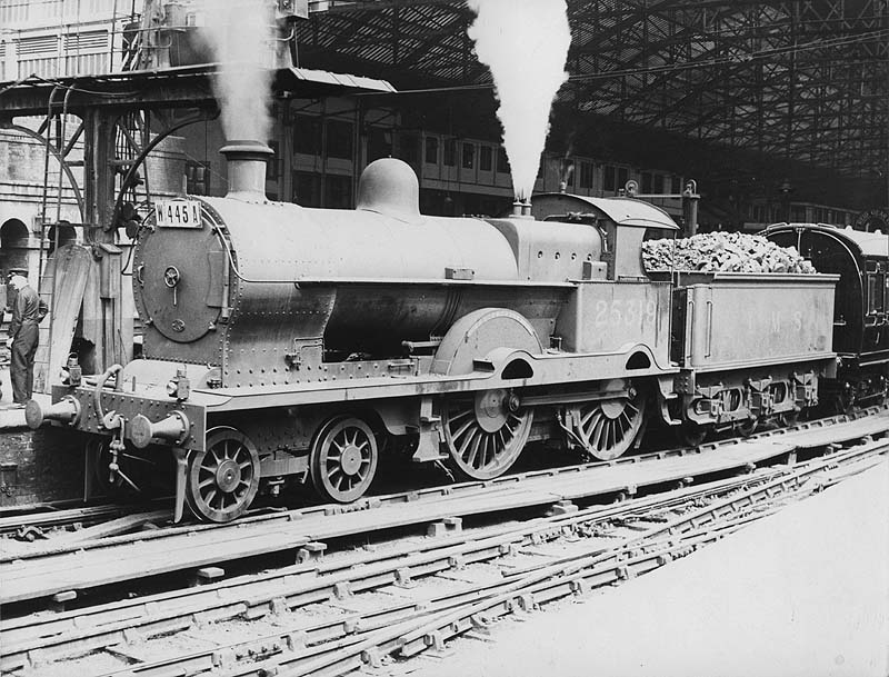 Ex-LNWR 4-4-0 No 25319 'Bucephalus' is seen standing at the West end of Platform 2 at the head of a down express to Wolverhampton