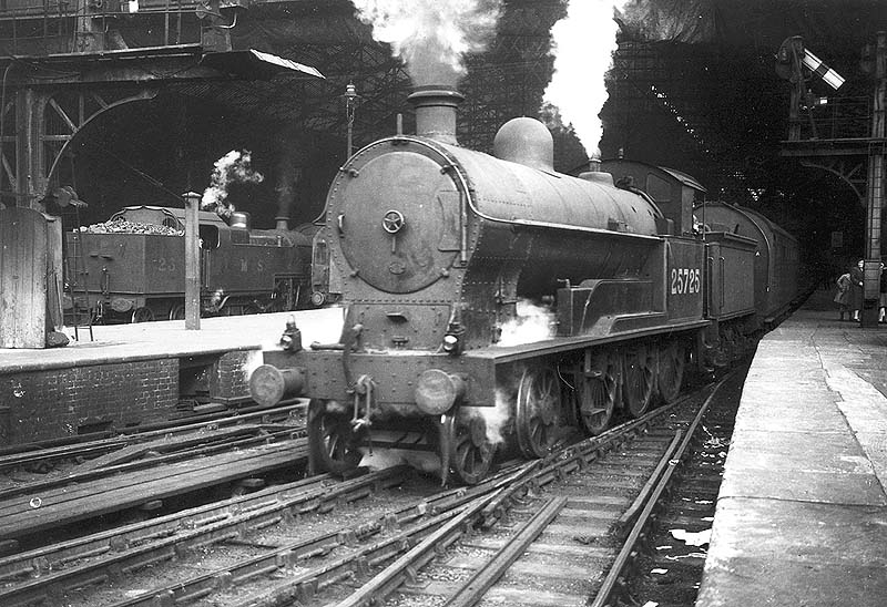 Ex-LNWR 4P 4-6-0 Prince of Wales class No 25725 is seen standing at the West end of Platform 3 at the head of a North of England express service