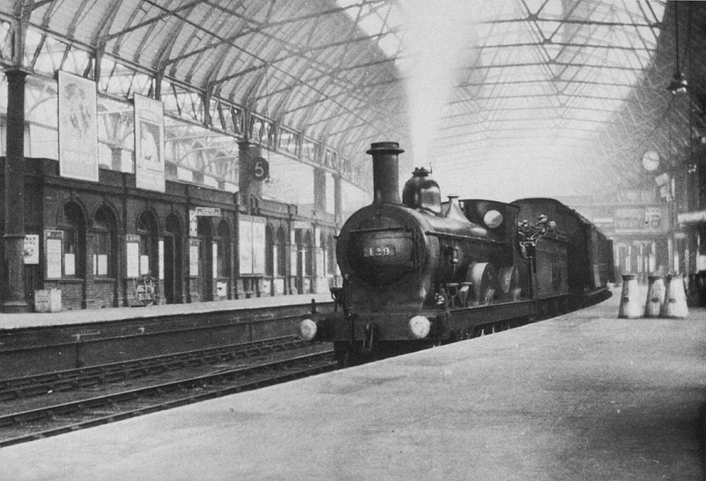 Ex-Midland Railway 2-4-0 No 129 is still carry its Midland livery whilst acting as pilot engine marshalling passenger stock at the West end of Platform Six