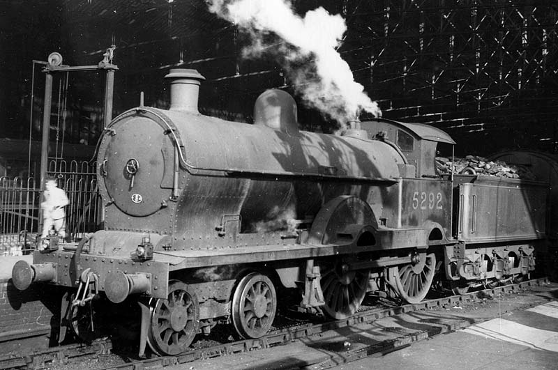 Ex-LNWR 3P 4-4-0 Precursor class No 5292 'Medusa' is seen blowing off steam at the West end of Platform 2 whilst at the head a down express