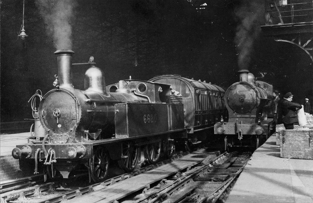 Ex-LNWR 1P 2-4-2T No 6620 stands at the West end of Platform 2 whilst waiting to take forward a local passenger service to Wolverhampton