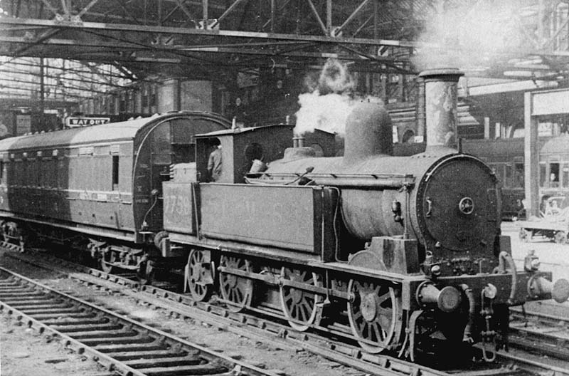 Ex-LNWR 0-6-2T No 7759, a Monument Lane locomotive, is seen shunting stock at the East end of the station during the demolition of the war-damaged great roof