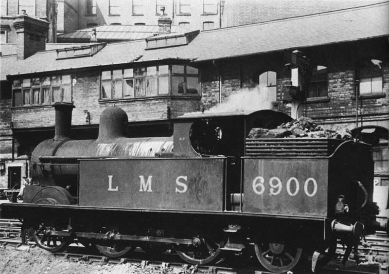 Ex-LNWR 0-6-2T 'Watford Tank' No 6900 is seen acting as pilot engine whilst standing at the West end of the station held by signals near New Street No 5 Signal Cabin