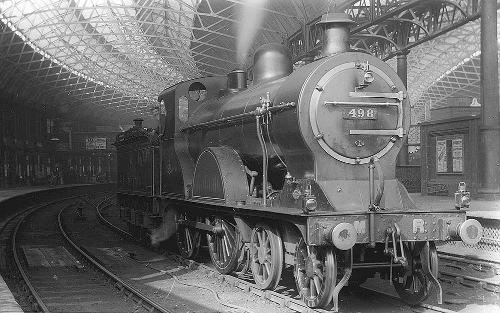 Midland Railway 2P 4-4-0 No 498 is seen standing light engine on the middle road between Platform 5 and 6 having brought in empty passenger stock