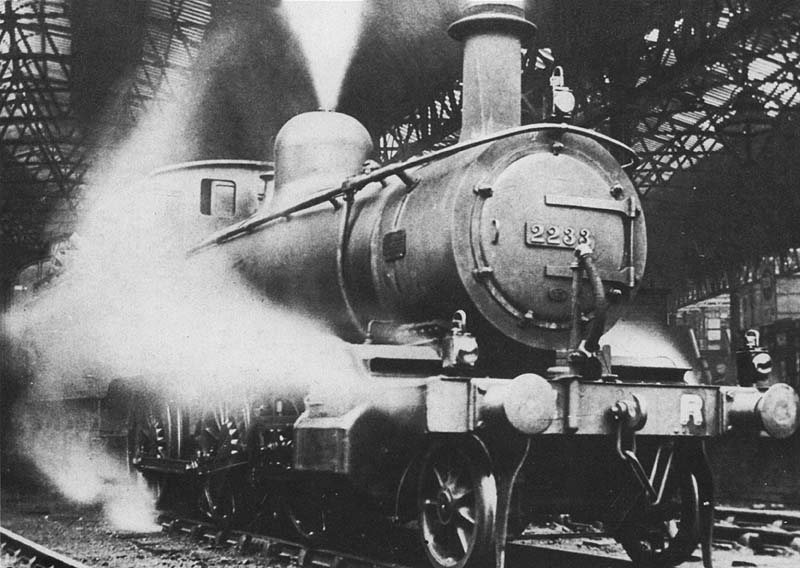 Midland Railway 2-6-0 No 2233, a 'Yankee Mogul', is seen standing on the centre road between Platforms 4 and 5 at the head of an empty passenger working