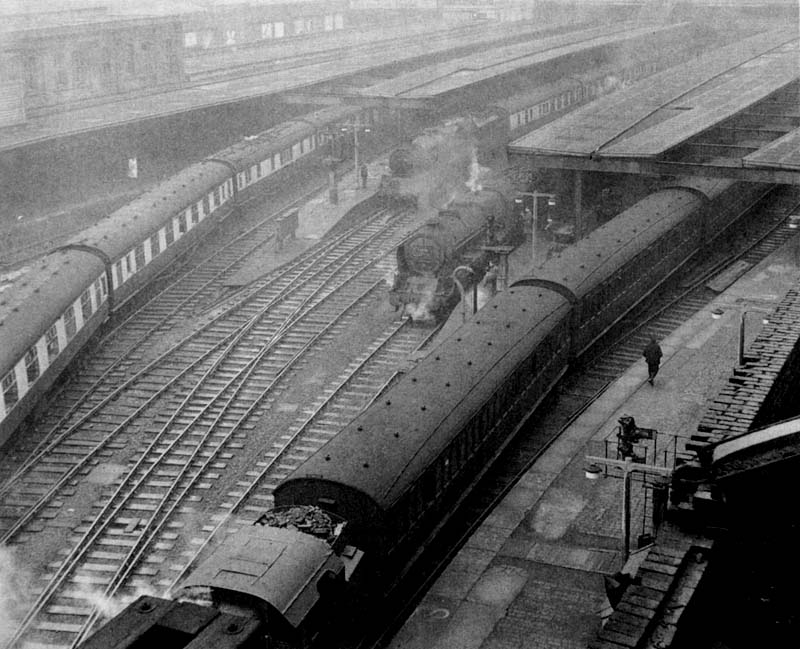 An elevated view of the East end of New Street station and Platforms 1, 2, 3 and 4 showing a local passenger train departing for Coventry