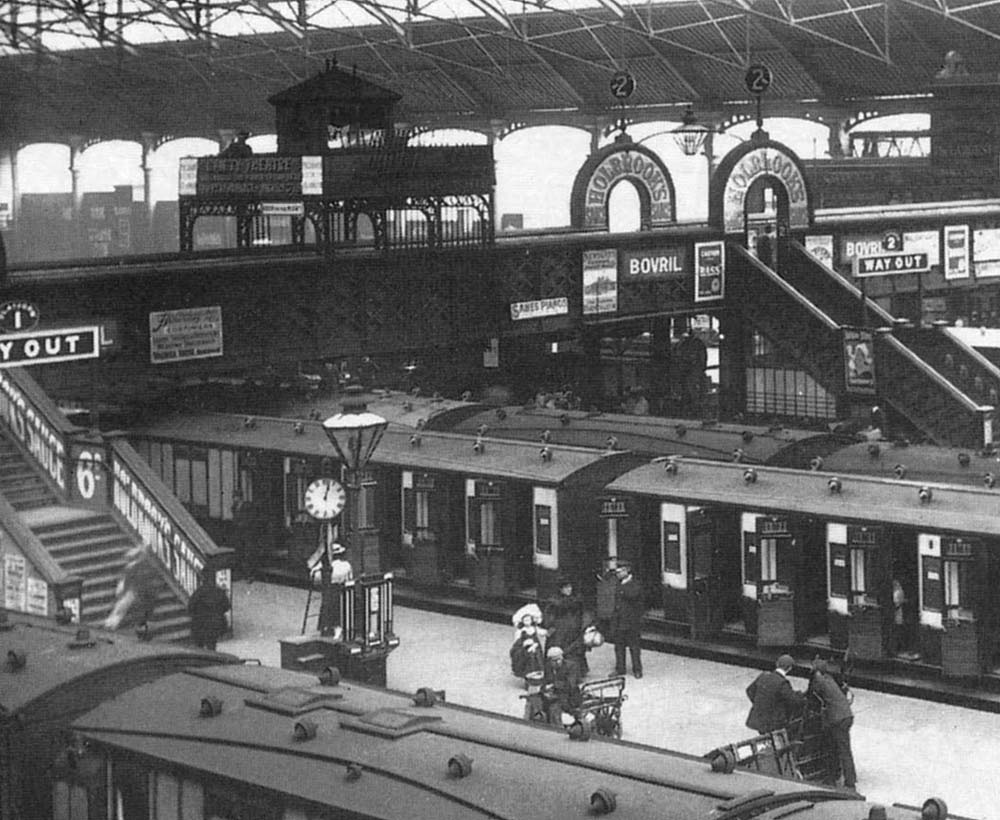 Close up showing a LNWR up express train standing at Platform 1's through platform with New Street No 3 signal cabin perched above