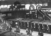 Close up showing a LNWR up express train standing at Platform 1's through platform with New Street No 3 signal cabin perched above