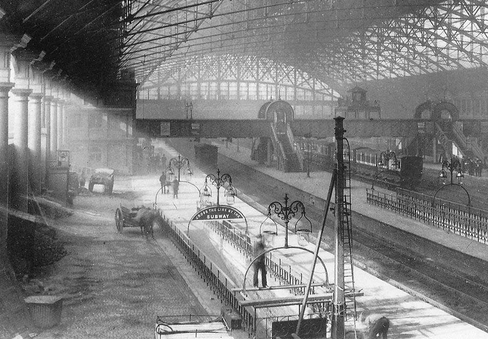 Close up showing the cleaning of one of the lamp's above the ramp on platform 3 whilst the platform's up signal is being repaired or altered