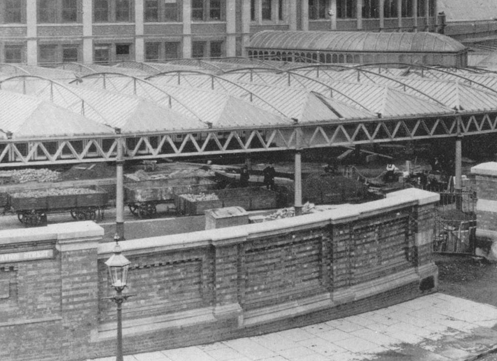 Close up showing the wagons being used on the remaining construction work which was still being undertaken a few months after the station had been opened for traffic