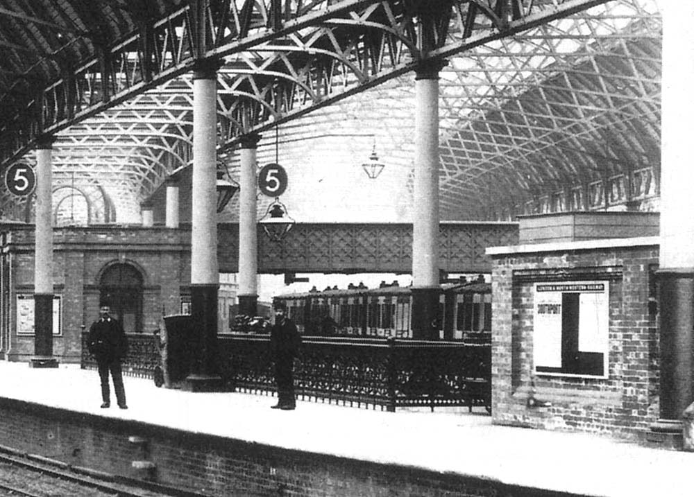 Close up of Platform 5 with the LNWR local passenger train behind and the Cashier's Office and Midland Agent's offices to the left