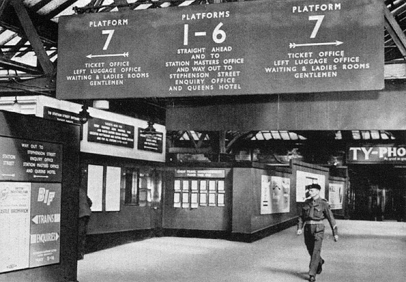 Looking along the passenger footbridge from Platform 7 towards Platform 1 and the Queens Hotel with the steps to Platform 7 on either side of the footbridge