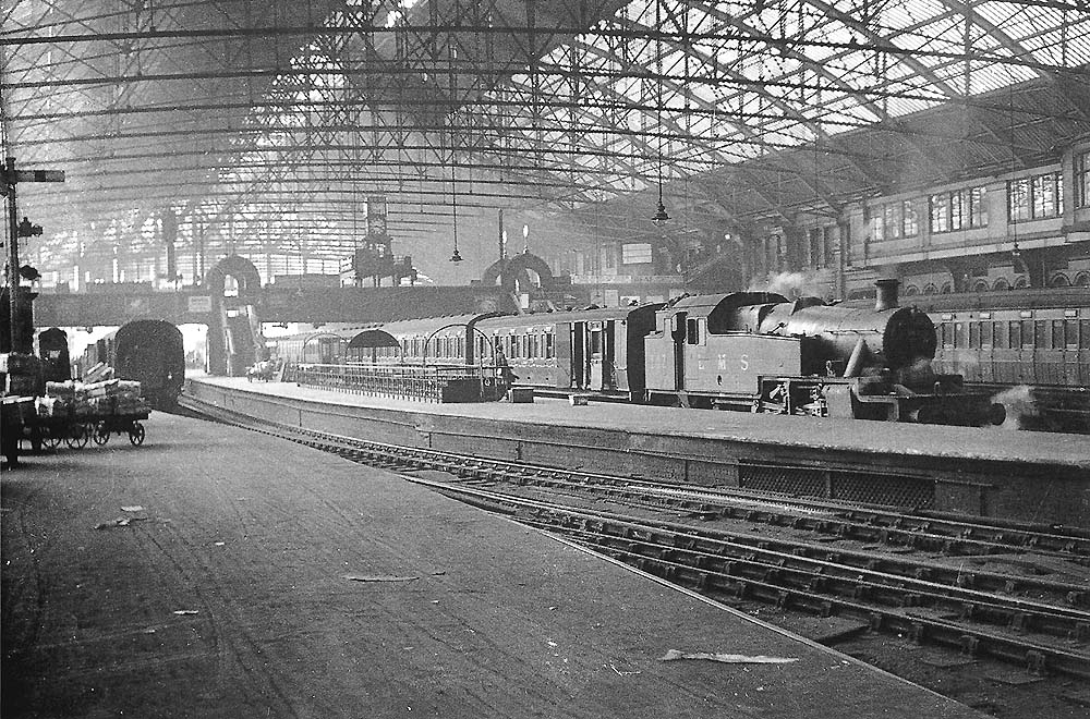 Looking towards the West end of Platform 3 from the parcels sidings with LMS 2-6-2T No 143 standing at the head of a Class B stopping passenger service