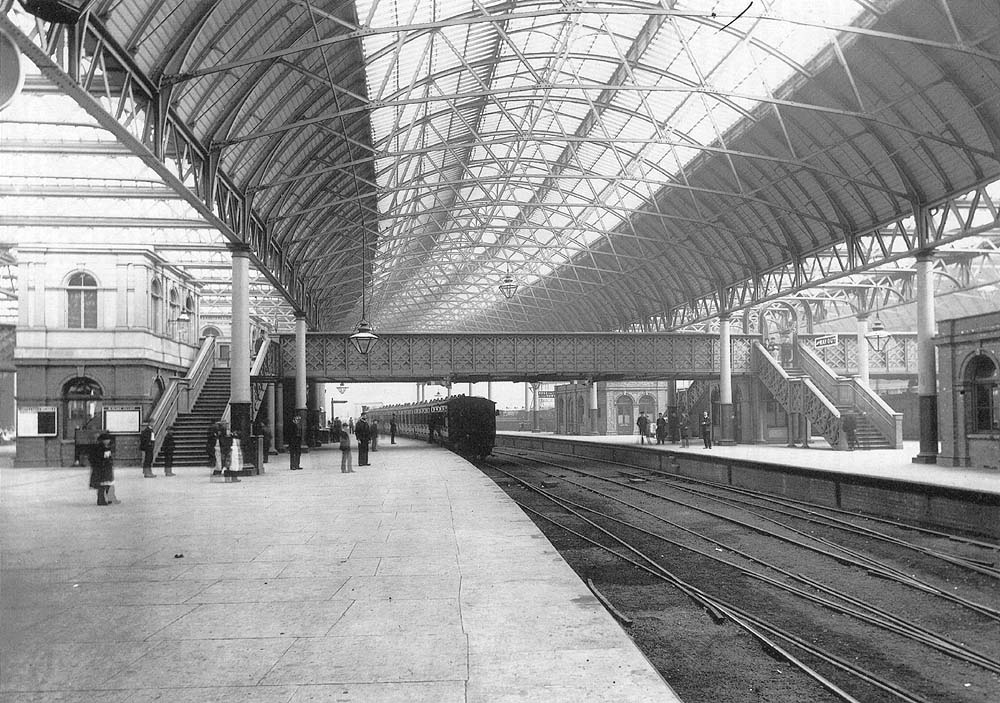 An early view of Platform 4 looking East with the entrance off Queens Drive to the left and with a MR train for Kings Norton standing in the platform