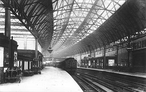 View of Platforms 4 and 5 looking towards the East of the station with a Midland Railway up train comprised of a variety of coaching stock standing in the station