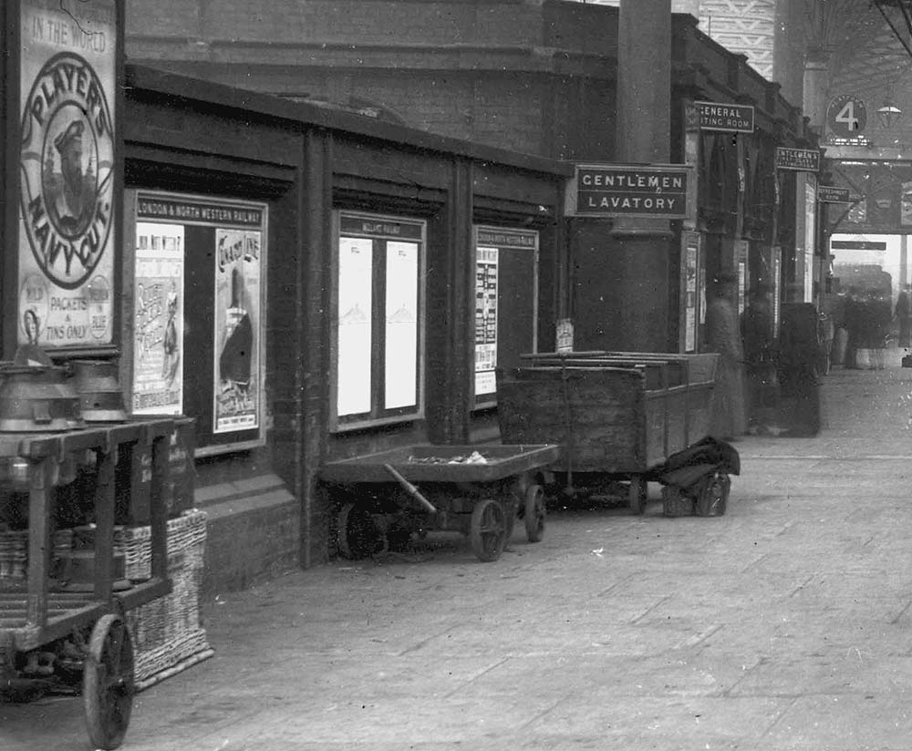 Close up of Platform 4 showing a variety of platform trollies used for carrying parcels, luggage and on the extreme left, for carriage oil lamps