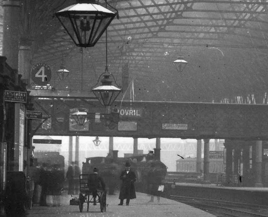 Close up with two unidentified Midland locomotives standing on the centre road and the cantilevered LNWR signal over the platform