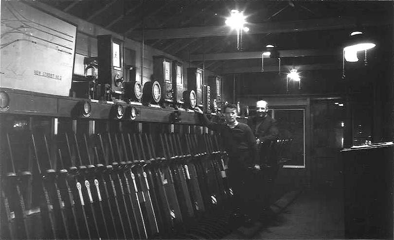An internal view of New Street No 2 Signal Cabin with two 'bobbies', Walter Pritchard and a Mr Bing, posing for the camera between duties on 20th March 1954