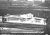 An elevated view of the snow covered disused and dismantled turntable situated opposite New Street No 5 Signal Box with the remains of the tank house behind