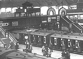 Close up showing a LNWR up express train standing at Platform 1's through platform with New Street No 3 signal cabin perched above