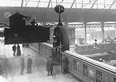 Close up showing the top of the steps to Western section of Platform 1 with a signalman standing on duty at New Street No 3 Signal Cabin