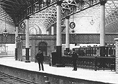 Close up of Platform 5 with the LNWR local passenger train behind and the Cashier's Office and Midland Agent's offices to the left