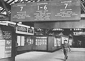 Looking along the passenger footbridge from Platform 7 towards Platform 1 and the Queens Hotel with the steps to Platform 7 on either side of the footbridge