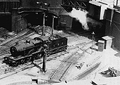 Close up showing an unidentified LMS 2P 4-4-0 standing on the down line leading from the Midland portion of the station