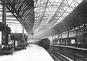 View of Platforms 4 and 5 looking towards the East of the station with a Midland Railway up train comprised of a variety of coaching stock standing in the station