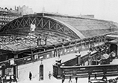 An elevated view of Queens Drive at the junction with Hill Street showing the original gated entrance and a row of Hansom Cabs queuing at the covered entrance