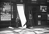 View of one of the hand-operated roller departure timetable blinds introduced by the LMS being changed at New Street station