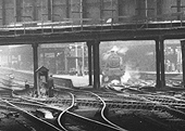 Close up looking under the bridge showing an unidentified ex-LMS 4-6-0 'Stanier Black 5' standing at Platform 4 with a down express service to Wolverhampton