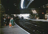 Looking along Platform 8 towards the West end of the station and New Street No 4 Signal Box as the sun streams through the roof on 1st August 1964