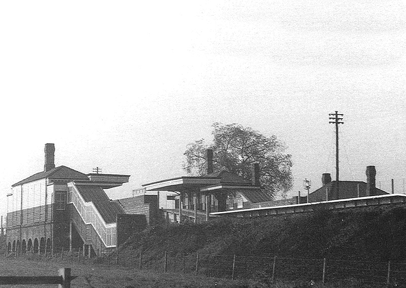 Close up showing the configuration of the station with passengers accessing the down platform from the up platform