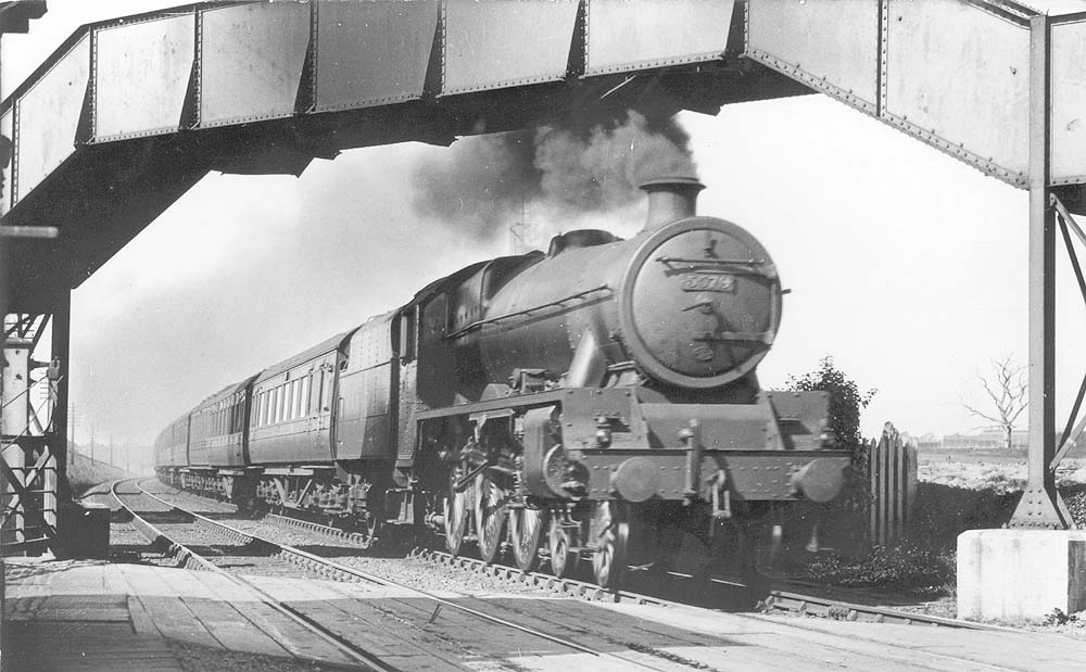 LMS 5XP 4-6-0 Jubilee class No 5579 'Punjab' passes under the footbridge on an up express prior to the Halt being built