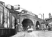Coton Arches the well known bridge with its wide shallow central arch being inspected in the 1960s