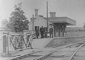 Close up showing Clifton Mill Station's Stationmaster standing with two members of staff and his children