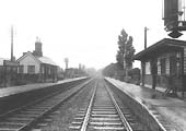 Looking towards Nuneaton station with one of the new colour light signals seen on the right on a wet 1st June 1964