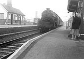 Ex-LMS 4-6-0 'Stanier Black 5' No 44915 is seen coasting through the station at the head of an express working to Coventry