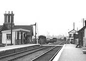 Close up showing Coundon Road level crossing and the station's up LNWR upper quadrant semaphore starter signal on the left