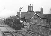 Ex-LMS 2-8-0 8F No 48767 is seen running light engine over Coundon Road Level Crossing in the early 1960s