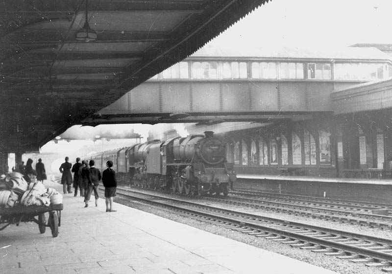 An unidentified ex-LMS 4-6-0 'Black 5' is seen double heading an ex-LMS 4-6-0 rebuilt Patriot class locomotive on a down express