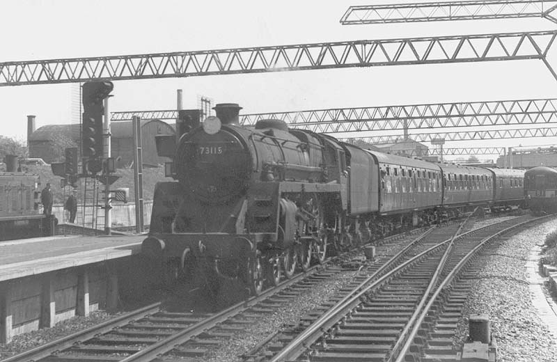 BR Standard 4-6-0 5MT No 73115 'King Pellinore' is seen entering Coventry station's new platform three as it comes off the Leamington branch