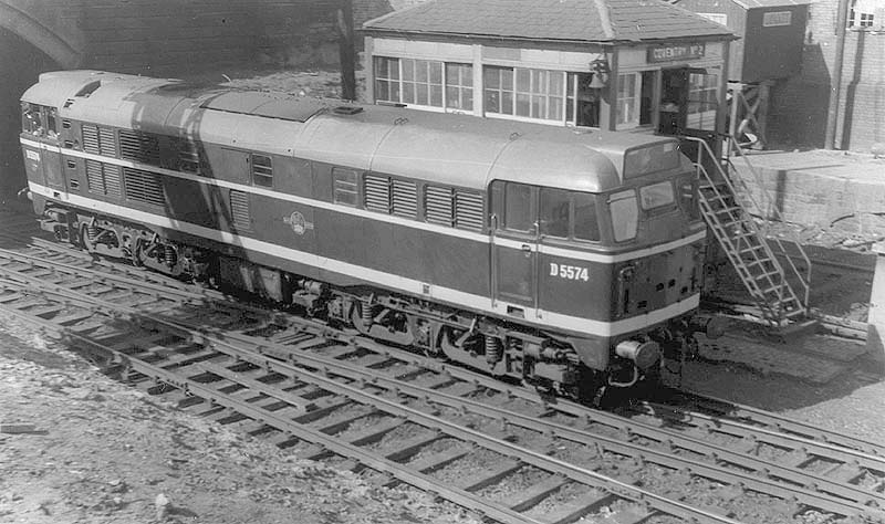 British Railways Type 2 Brush D5574 is seen on parcels duty and is running wrong line past Coventry No 2 Signal box