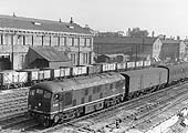 British Railways Type 2 Diesel D5019 is seen passing the Coventry No 1 Goods shed on a down freight service to Birmingham