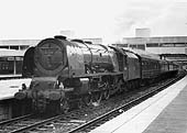 Ex-LMS 4-6-2 8P Coronation class No 46240 'City of Coventry stands at Coventry station's new platform three with down Euston to Birmingham express