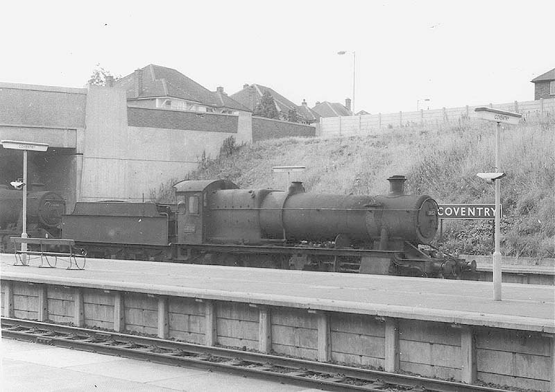 Ex-GWR 2-8-0 Class 28xx No 3832 is seen piloting an unidentified ex-LMS 2-8-0 8F as it passes through Coventry station's new platform four