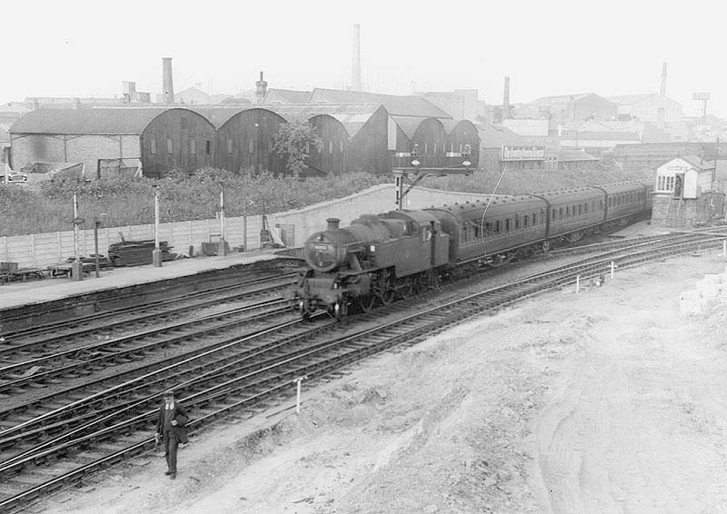 An unidentified ex-LMS 2-6-4T is seen at the head of a Rugby to Birmingham local passenger train as it approaches platform two